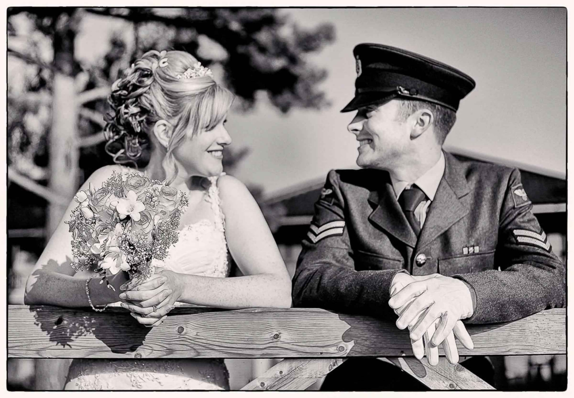 Black and white wedding portrait of a bride and her groom in military uniform, South Wales
