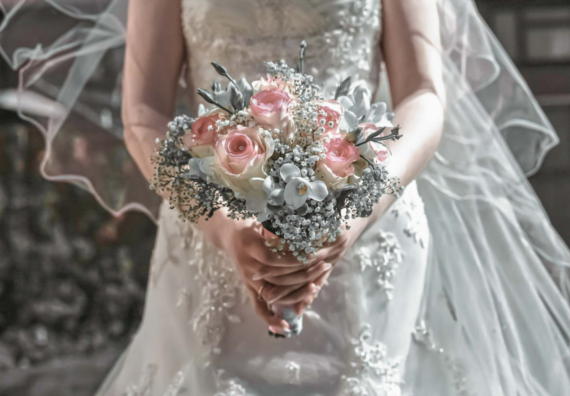 Bride holding a pink and white rose bouquet beneath a flowing veil, Newport wedding photography