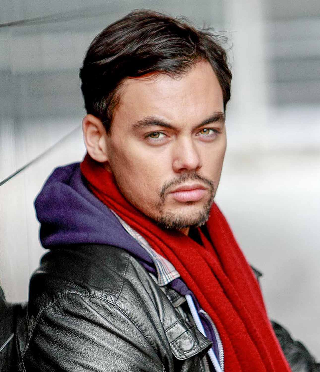 Actor's portrait of a man in a leather jacket and red scarf, Newport photo studio